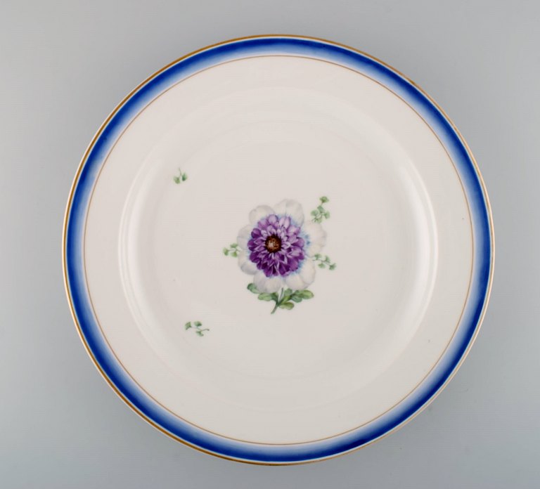 Large round antique Royal Copenhagen dish in hand-painted porcelain with flowers and blue edge with gold. Model number 592/9042. Late 19th century.