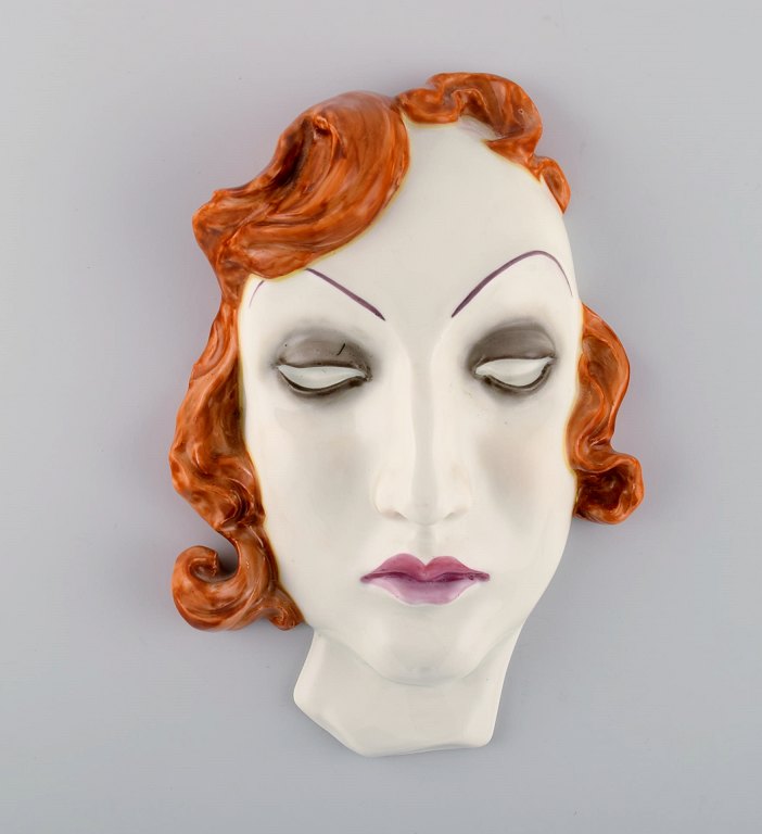 Art deco female face in hand-painted glazed ceramics. Germany, 1950s.
