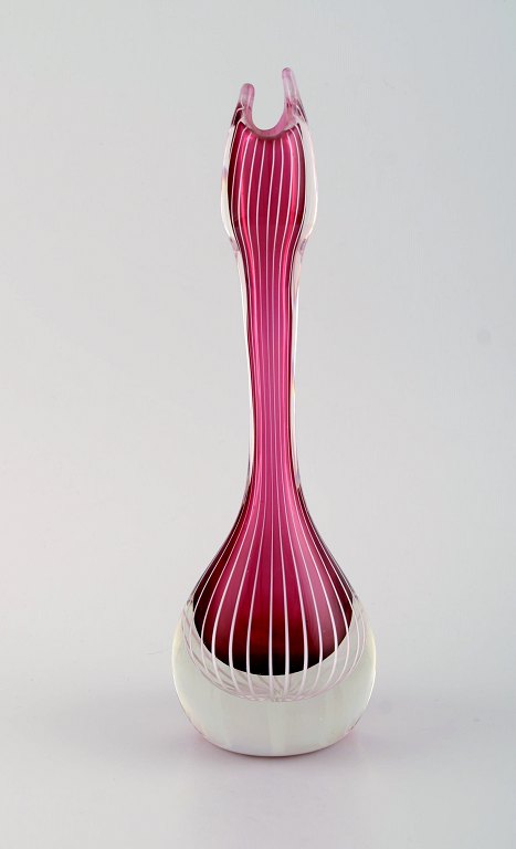 Swedish glass artist. Organically shaped vase in violet and clear mouth blown art glass with white stripes. Swedish design, mid 20th century.