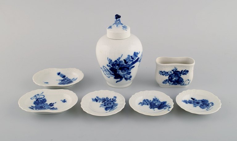 Royal Copenhagen Blue Flower Curved. Toothpick holder, tea caddy and five butter pads in porcelain with flower decoration.
