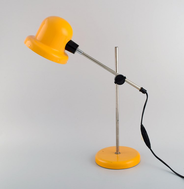 Swedish designer. Adjustable retro desk lamp in yellow lacquered metal and chrome. 1970s.