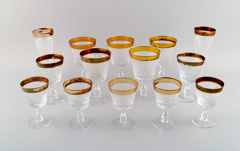 14 glasses in mouth-blown crystal glass with gold edge. France, 1930s.