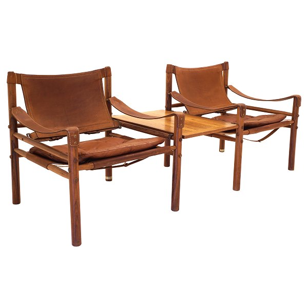 A pair of Arne Norell Scirocco rosewood safari chairs with table. Both chairs with original label. Design Sweden 1964