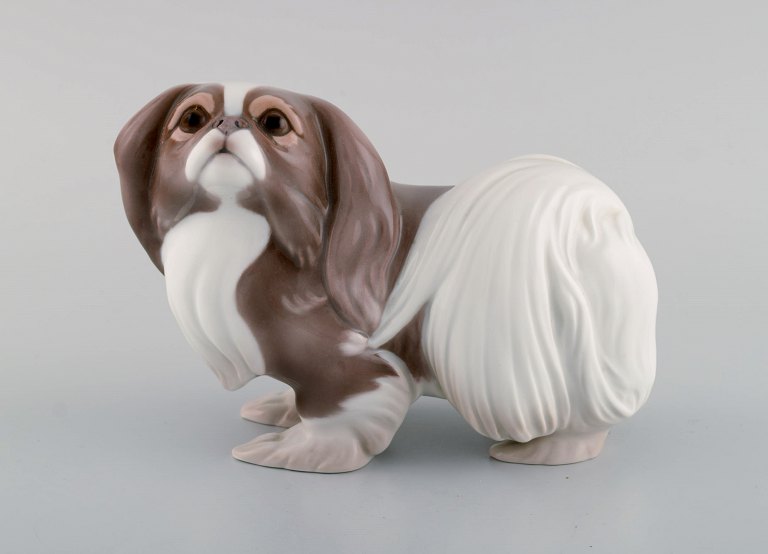 Sveistrup Madsen for Bing & Grøndahl. Porcelain figure. Standing Pekingese. Mid-20th century.