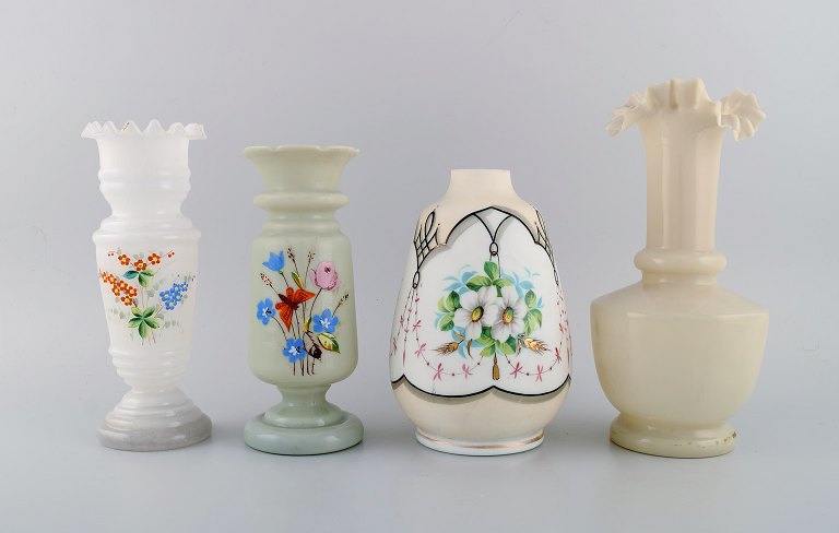 Four antique vases in hand-painted mouth-blown opal art glass. Approx. 1900.