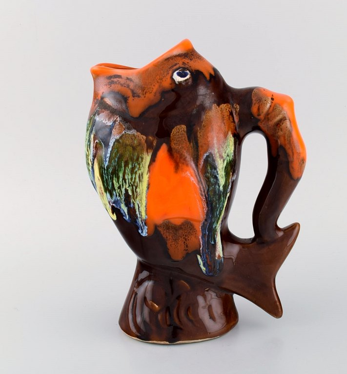 Belgian studio ceramicist. Retro jug in glazed ceramisc shaped like a fish. Beautiful glaze in brown and orange shades. 1960s / 70s.