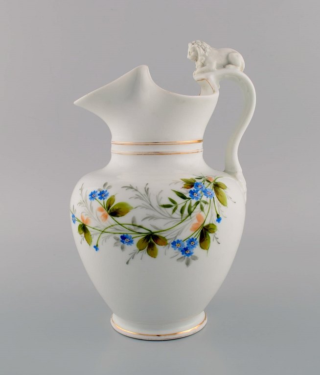 Antique Bing & Grøndahl chocolate jug in porcelain modeled with a lion on the handle. Hand-painted flowers and gold decoration. 1870s.