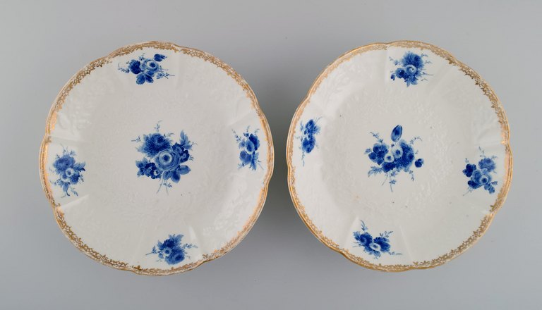Two antique Meissen deep plates with foliage in relief, hand-painted flowers and gold edge. Dated 1732-1773.