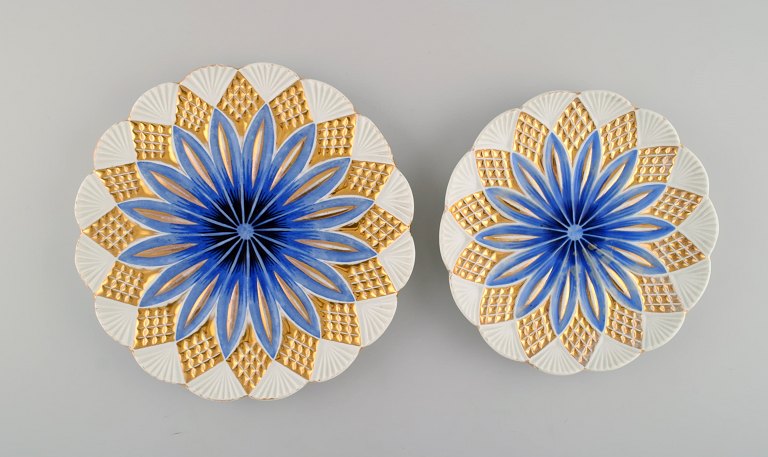 Two antique Meissen plates in hand-painted porcelain. Blue flowers and gold decoration. Early 20th century.