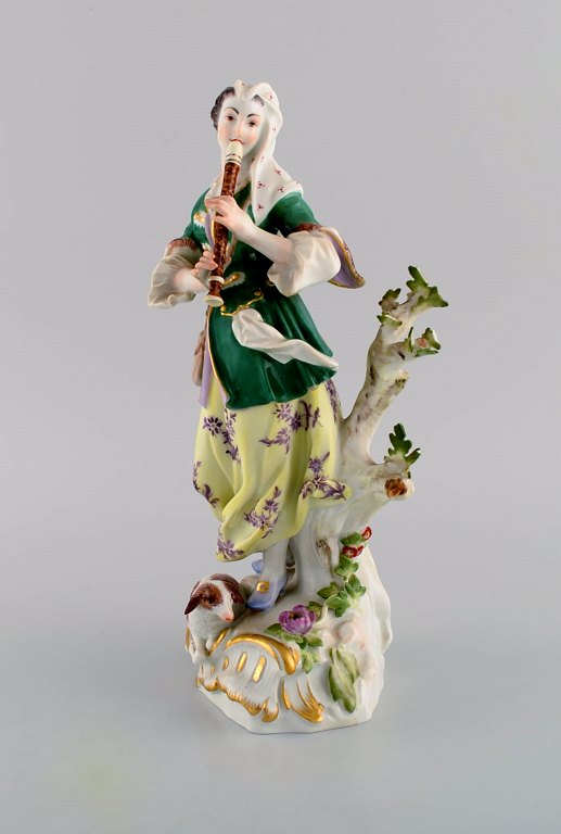 Antique Meissen porcelain figurine. Woman playing flute. Late 19th century.