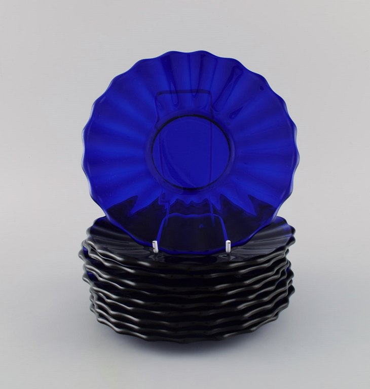 Monica Bratt for Reijmyre. 10 plates in blue mouth blown art glass. Wavy design. Mid-20th century.