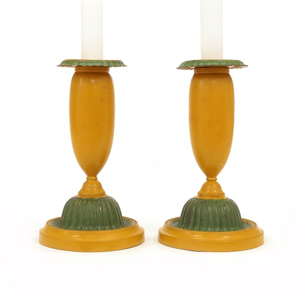 A pair of green and yellow decorated pair of candle sticks. Denmark circa 1840-50. H: 19cm