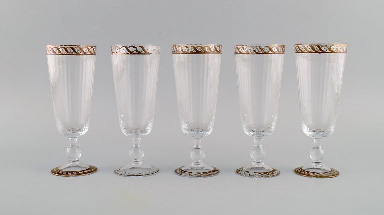 Nason & Moretti, Murano. Five wine glasses in mouth-blown art glass with hand-painted turquoise and gold decoration. 1930s.