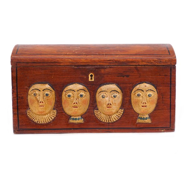 An early 19th century original decorated wooden box with wood cut faces. Denmark circa 1800. H: 14cm. L: 26cm. D: 13cm