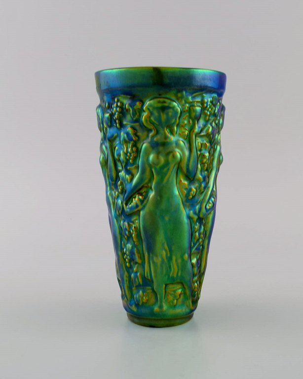 Zsolnay vase in glazed ceramics modeled with women picking grapes. Beautiful luster glasses. Mid-20th century.