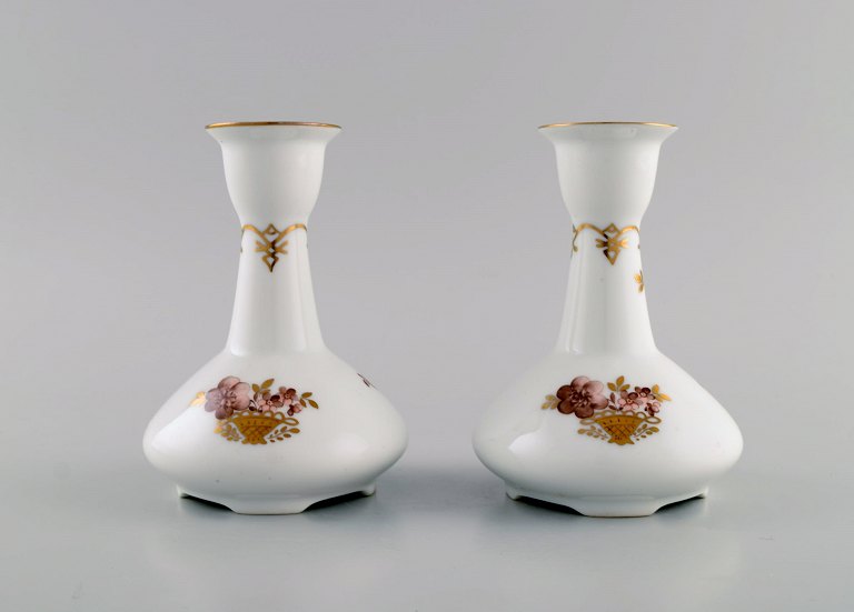 Two Royal Copenhagen Golden Basket candlesticks in porcelain with flowers and gold decoration. Model number 595/430.
