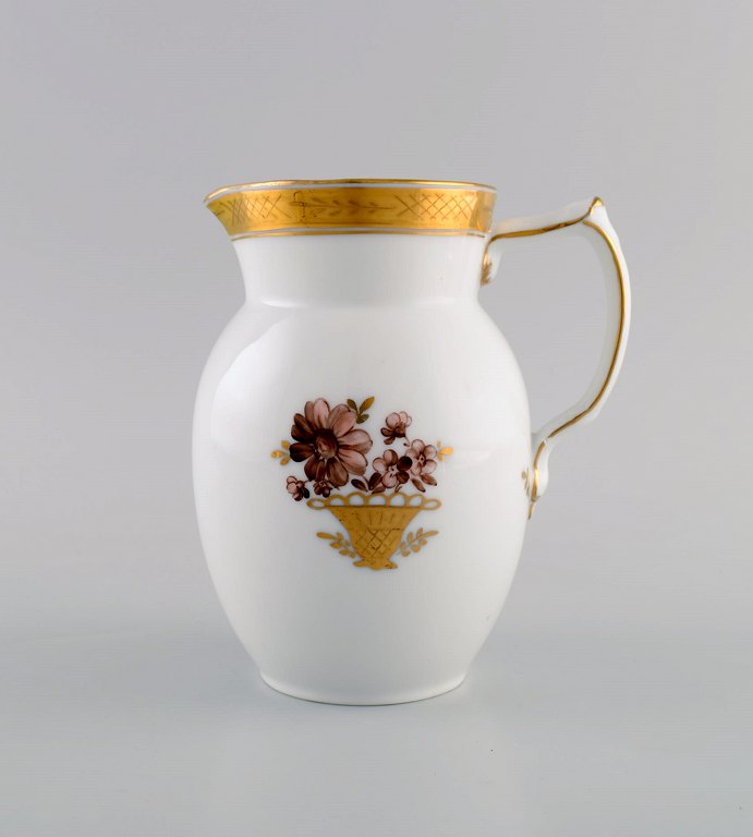 Royal Copenhagen Golden basket jug in porcelain with flowers and gold decoration. Model number 595/9235. Early 20th century.