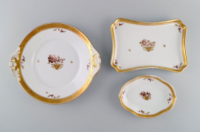 Three Royal Copenhagen Golden Basket dishes in porcelain with flowers and gold decoration. Early 20th century.