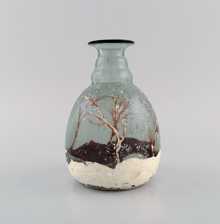 Daum Nancy, France. Art nouveau vase in mouth blown art glass with hand-painted snowy landscape. Early 20th century.