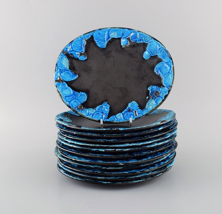 French ceramist. Twelve lunch plates in glazed stoneware. Beautiful glaze in azure shades. Unique, high-quality ceramics. Mid-20th century.