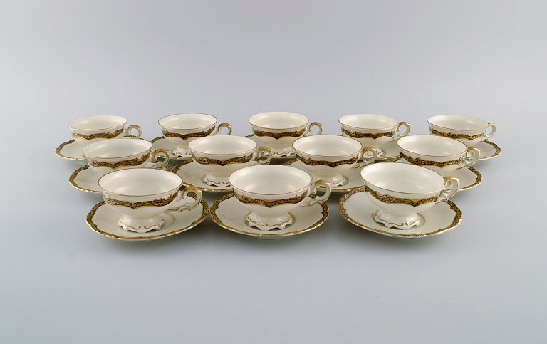 KPM, Berlin. Twelve Royal Ivory tea cups with saucers in cream-colored porcelain with gold decoration. 1920s.