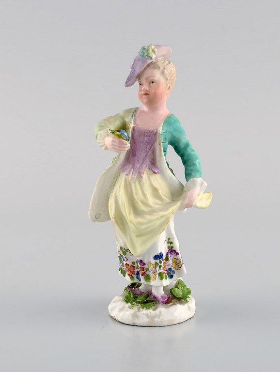 Meissen, Germany. Antique hand-painted porcelain figure. Lady with flowers. Late 19th century.
