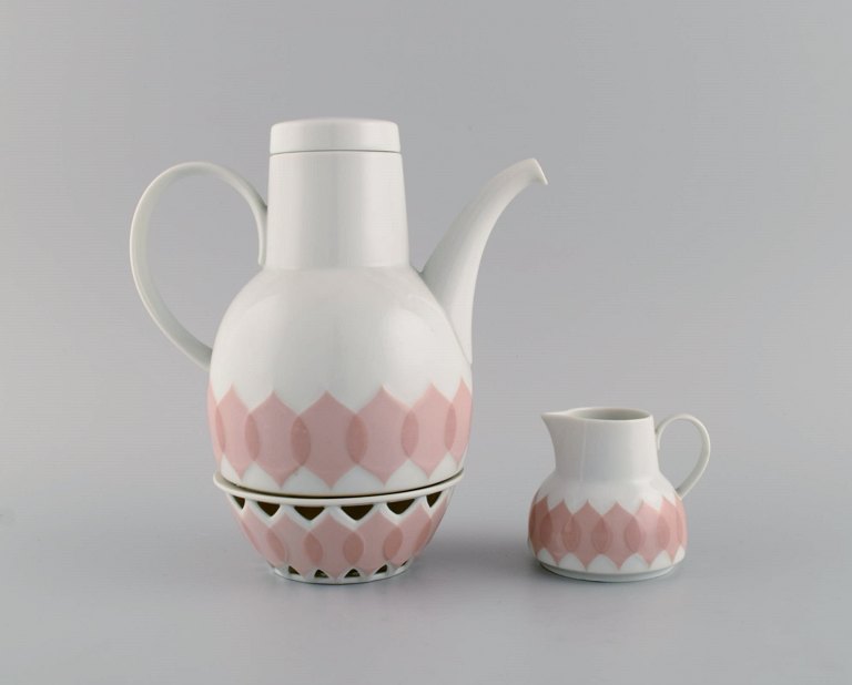 Bjørn Wiinblad for Rosenthal. Lotus porcelain service. Coffee pot with heater for tealight candles and creamer decorated with pink lotus leaves. 1980s.