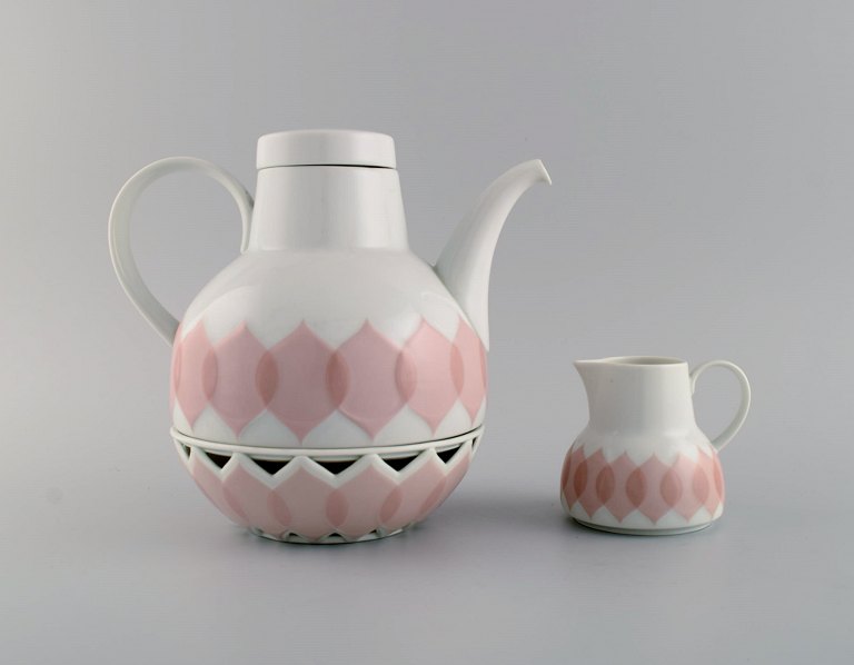 Bjørn Wiinblad for Rosenthal. Lotus porcelain service. Teapot with heater for tealight candles and creamer decorated with pink lotus leaves. 1980s.