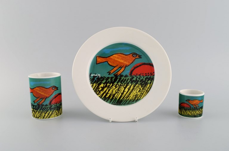 Corneille (Guillaume Cornelis van Beverloo), Dutch CoBrA artist (1922-2010). Coffee cup, plate and egg cup in porcelain decorated with birds over field with sunrise. 1980s / 90s.