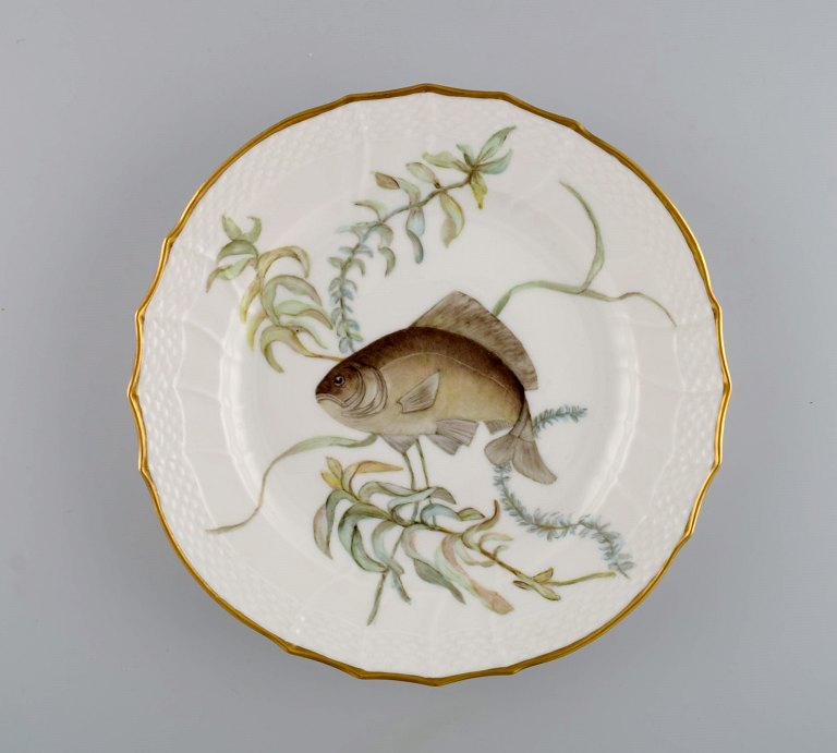 Royal Copenhagen porcelain lunch plate with hand-painted fish motif and golden border. Flora / Fauna Danica style. Dated 1965.