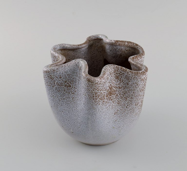 European studio ceramicist. Unique wavy edged vase in glazed stoneware. Beautiful speckled glaze. 1960s / 70s.