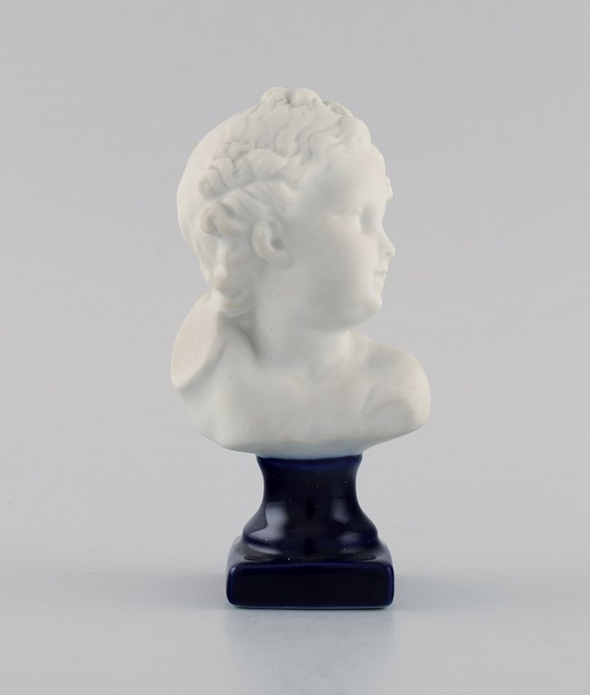 Limoges France. Biscuit child bust. Stand with dark blue glaze. Classic style. Early 20th century.