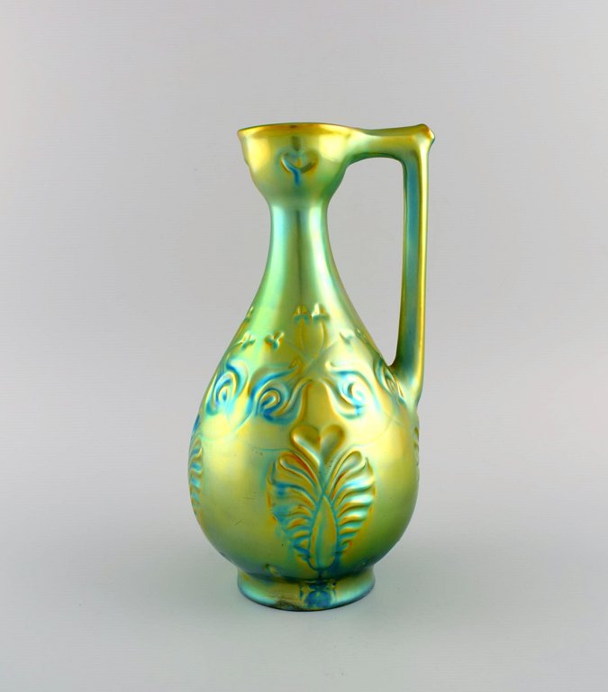 Zsolnay jug in glazed ceramics modeled with foliage. Beautiful eosin glaze. 1960s.