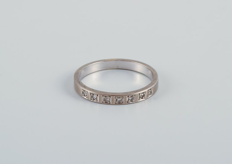 Scandinavian goldsmith. Classic alliance ring in white gold adorned with seven diamonds.