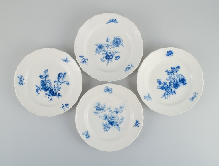 Four antique Meissen dinner plates.Hand painted with various blue flowers and butterflies.