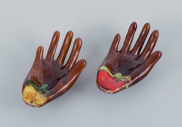 Vallauris, France, a pair of ceramic bowls shaped like hands in brightly colored glazes.