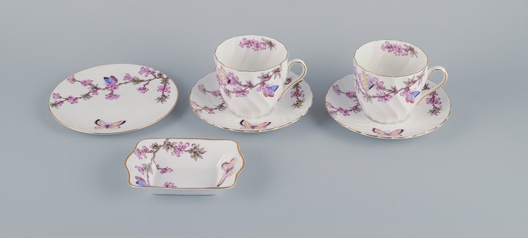 Tuscan, England, Bone China. Two pairs of large coffee cups, a plate and a small bowl decorated with butterflies and cherry blossoms.