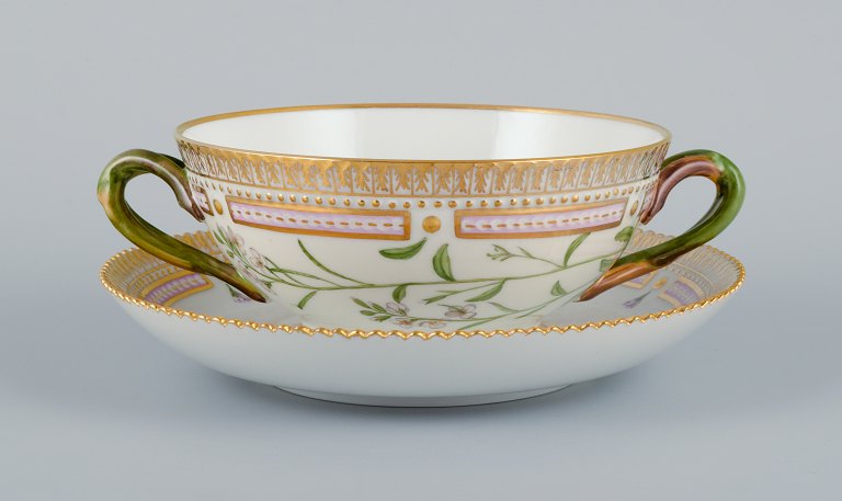 Royal Copenhagen Flora Danica boullion cup with saucer in hand-painted porcelain with branch-shaped handles, flowers and gold decoration. PROVENANCE : VALDEMARS CASTLE
