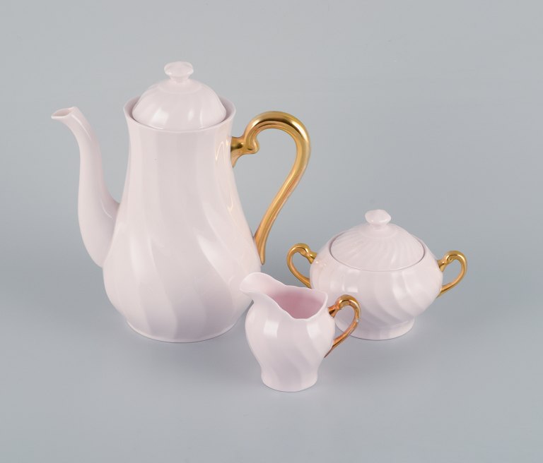 Tuscan, England, coffee service in pink porcelain with gold decoration consisting of coffee pot, creamer and sugar bowl.