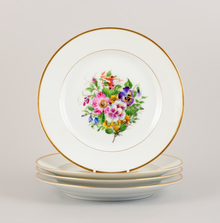 Bing & Grøndahl, four dinner plates in porcelain hand-painted with polychrome flowers and gold decoration.