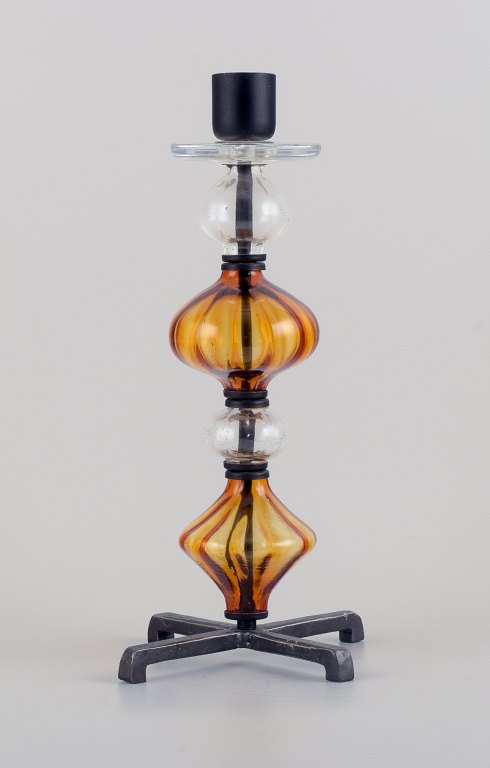 Erik Höglund for Kosta Boda. Tall candlestick holder made of mouth-blown glass and cast iron.