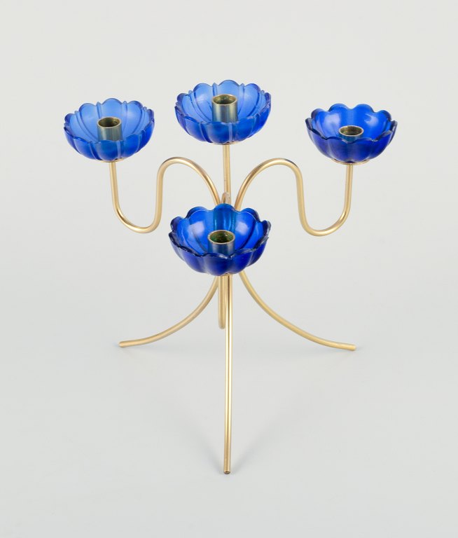 Gunnar Ander for Ystad Metall, a brass candle holder for four candles with blue candle sleeves.
