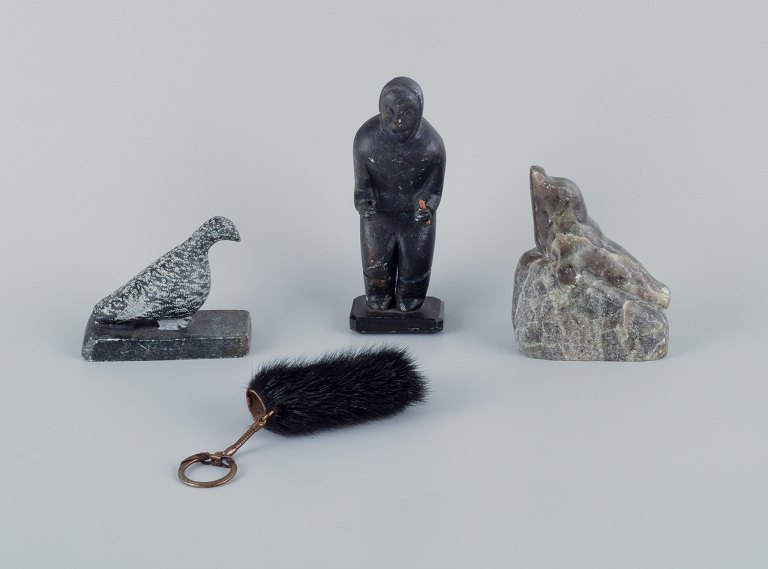 Greenlandica, three pieces of soapstone and a black pouch with a keyring. Features a ptarmigan, seal, and hunter.