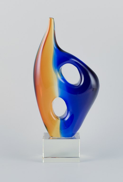 Murano, Italy, art glass sculpture in blue and syrup-colored glass on a clear glass base.