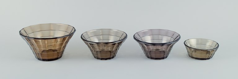 Simon Gate (1883-1945) for Orrefors/Sandvik, Sweden.A set of four Art Deco bowls in smoked coloured pressed glass.