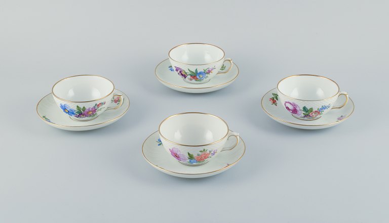 Royal Copenhagen, Saxon Flower, a set of four tea cups with saucers hand-decorated with polychrome flowers and gold rim.