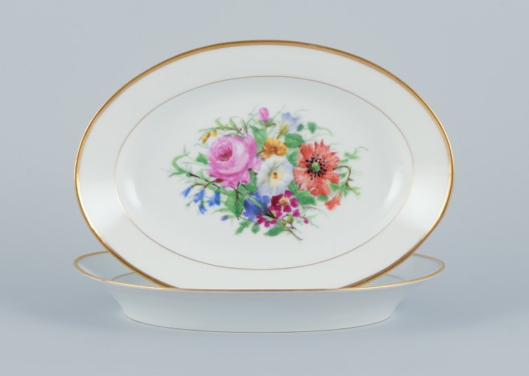 Bing & Grondahl, two oval platters hand-painted with polychrome flower motifs and gold trim.