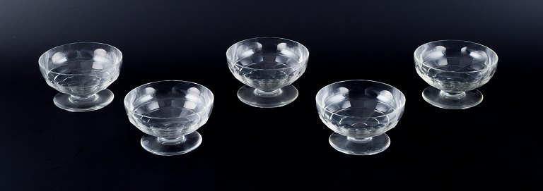 Baccarat, France, a set of five "Charmes" Art Deco champagne coupes in clear crystal glass. Faceted cut.