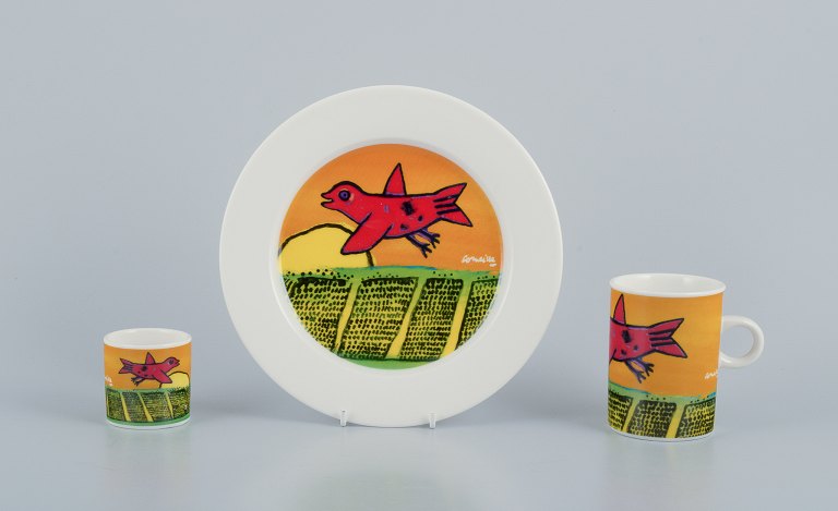 Corneille (Guillaume Cornelis van Beverloo), Dutch CoBrA artist (1922-2010). Coffee cup, plate, and egg cup in porcelain decorated with birds over a field with sunrise.