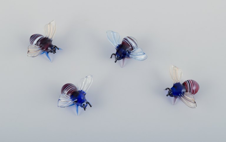 Murano, Italy. A collection of four miniature glass figurines of bees in colored art glass.